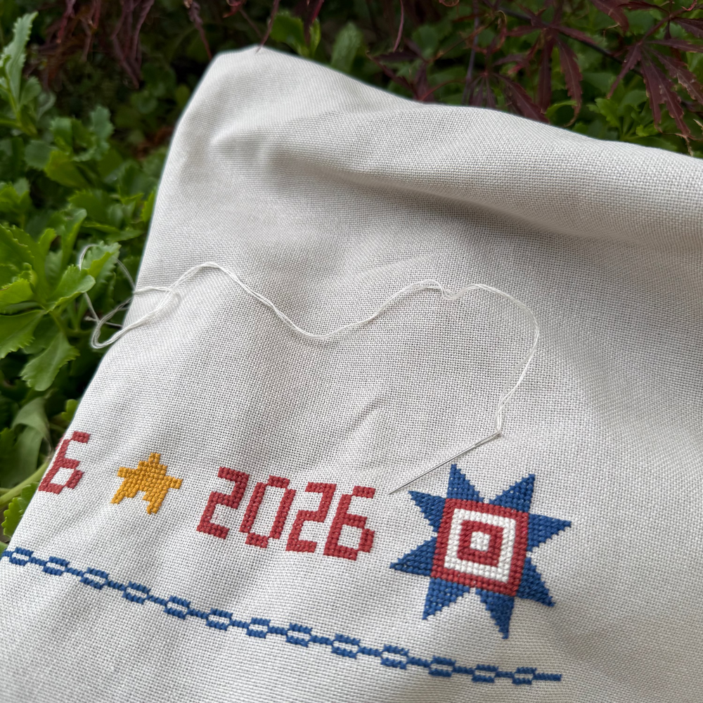 Embroidered fabric with stars and numbers on a natural background