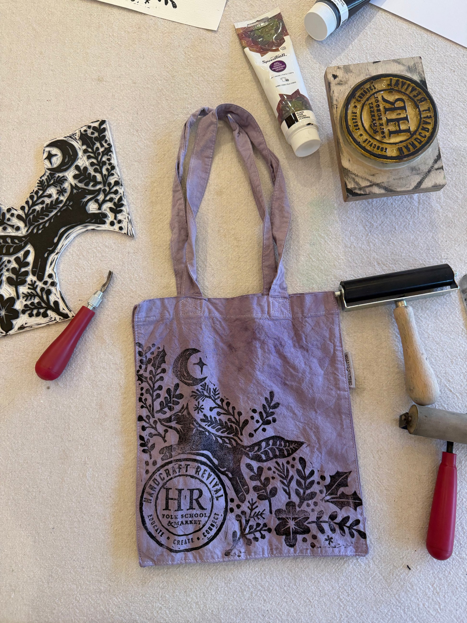 Stamps, ink pad, and printed fabric on a flat surface